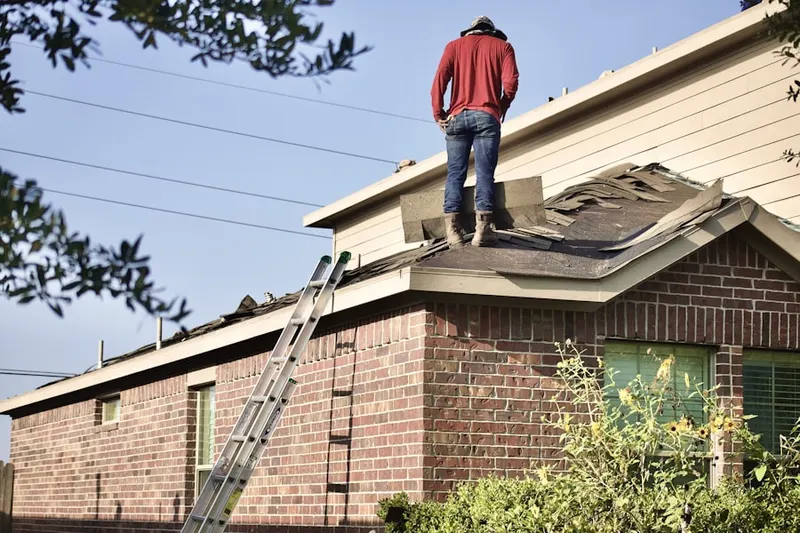 Professional roofer working on a residential roof in Sandy Ridge Terrace